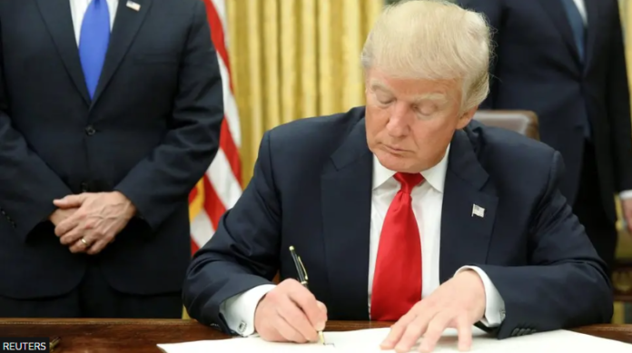 Trump-signing-696x389