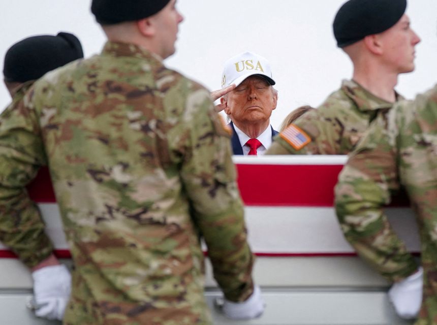 President Donald Trump salutes during a dignified transfer at Dover Air Force Base on March 7.